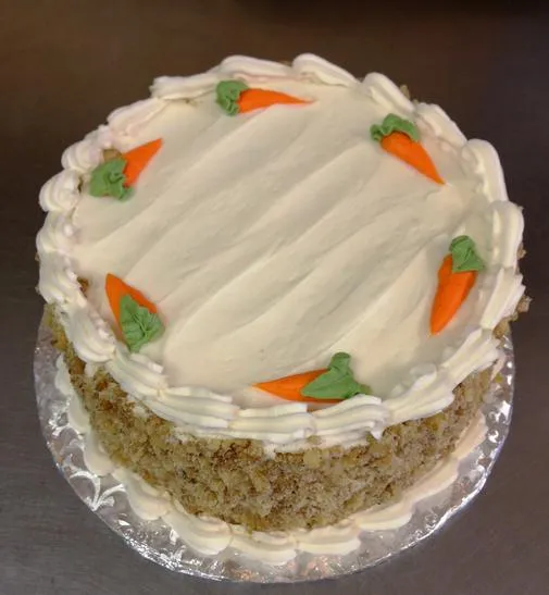 Carrot cake with cream cheese icing and piped carrots